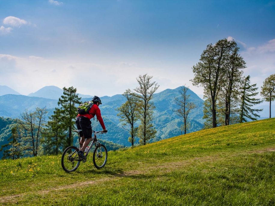 A mountain biker on a day ride from Slovenia's capital Ljubljana with the Polhov Gradec Hills in the background