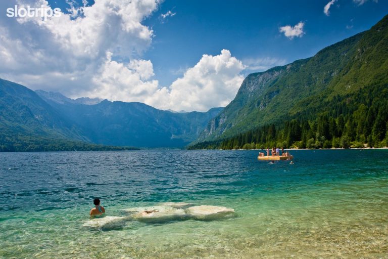Refreshing swimming on a summer day at Lake Bohinj in the Julian Alps in Slovenia