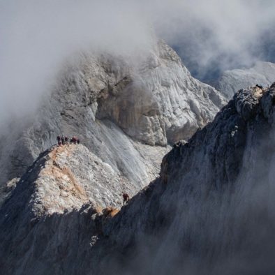 A group of hikers on a mountain ridge on the ascent to Mt. Triglav in the Julian Alps, Slovenia