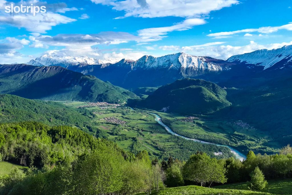 The middle part of the Soca Valley with the Soca River and snow-capped Julian Alps as seen from the WWI Outdoor museum on the Kolovrat mountain range in Slovenia