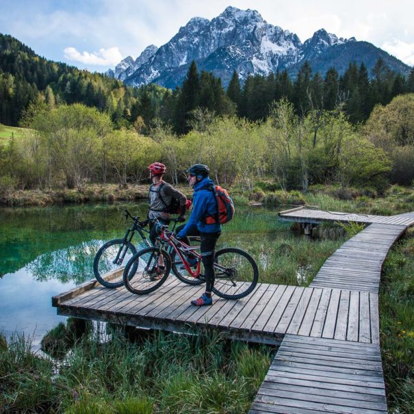 Two mountain bikers taking a break at Zelenci springs close to Kranjska Gora Ski Resort in Slovenia