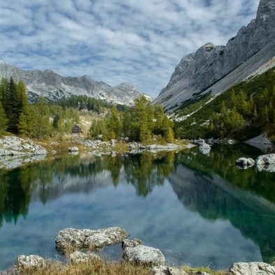 Beautiful deep green Double Lake reflecting mountains and forests above the Seven Triglav Lakes mountain hut.