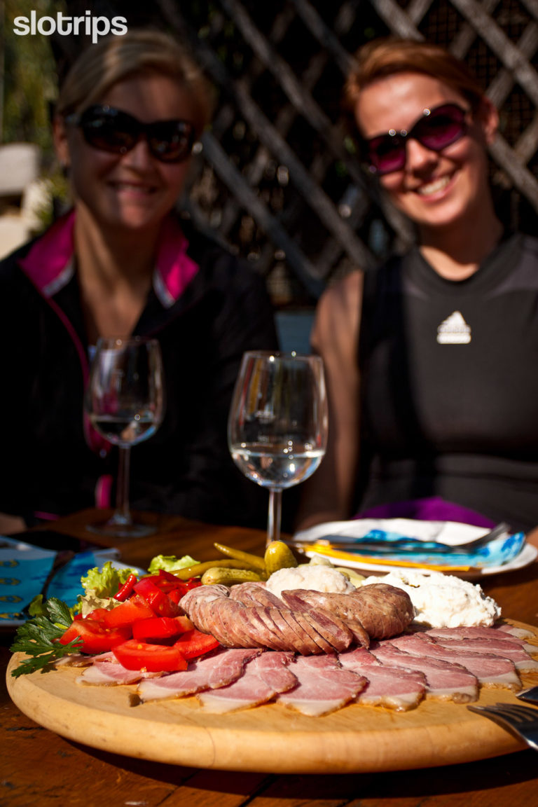 Home produced cold cuts traditional for Styria region of Slovenia with a glass of delicious local wine