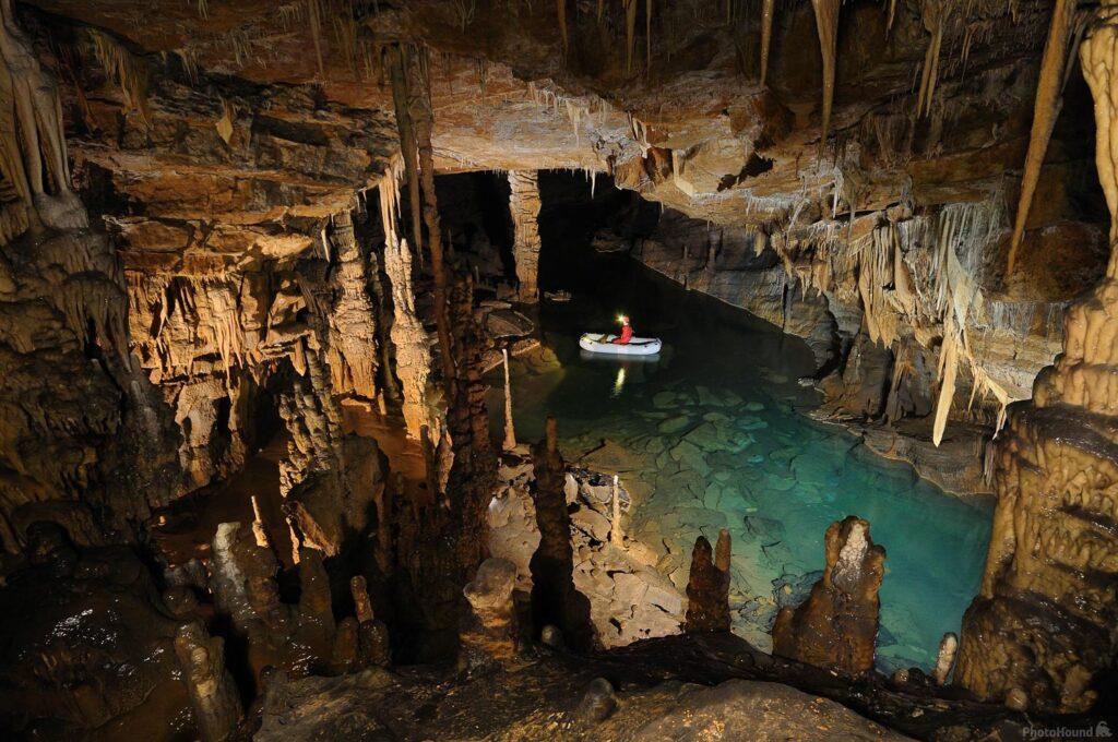 Rowing a boat in Cross Cave near Cerknica, Slovenia
