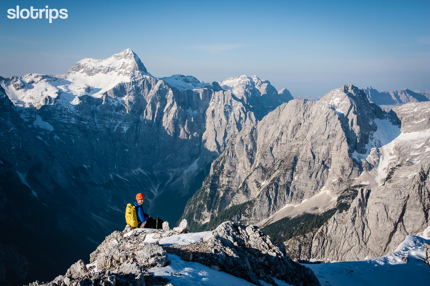 Happy hiker enjoying an amazing view of Triglan North Wall, Julian Alps