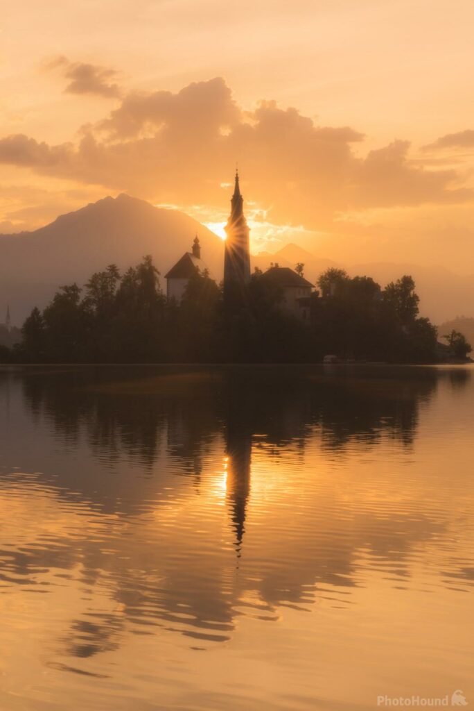 Sun rising behind the church on Lake Bled island