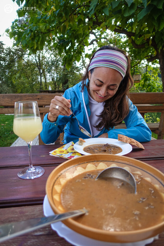 Woman enjoying a gulash and must (grape juice) in Styria wine region, Slovenia