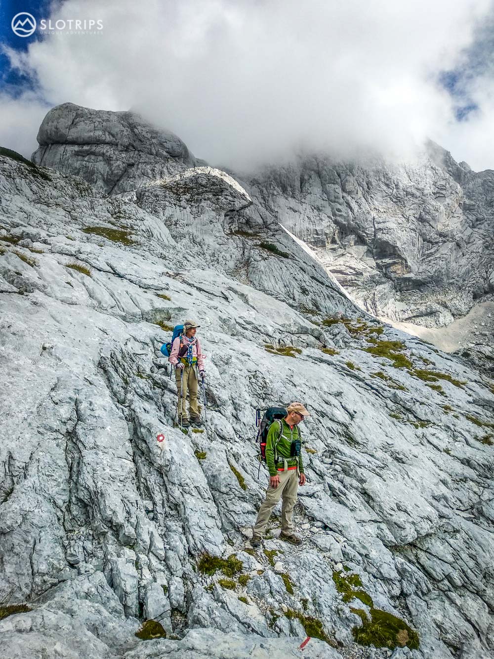 Two hikers on rocky trails in Kamnik-Savinja Alps