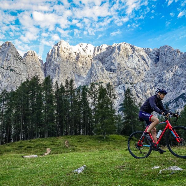 A gravel biker climbing towards the Vrsic Pass in Triglav National Park in Slovenia.