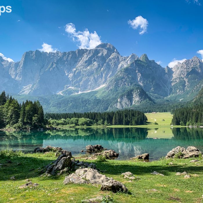 Lago del Predil with the towering mountain of the Julian Alps in the background